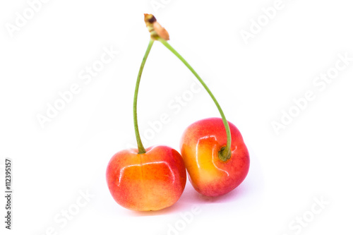 Two yellow cherries isolated on the white background