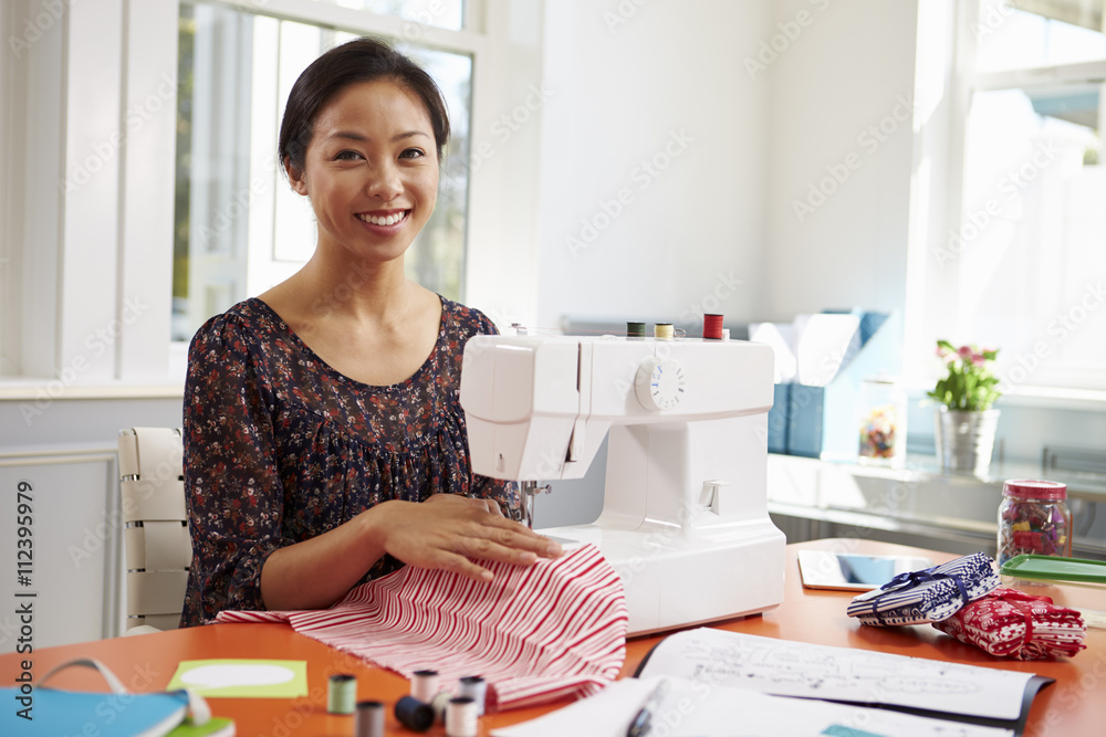 Woman Making Clothes Using Sewing Machine At Home Woman Making Clothes Using Sewing Machine At Home