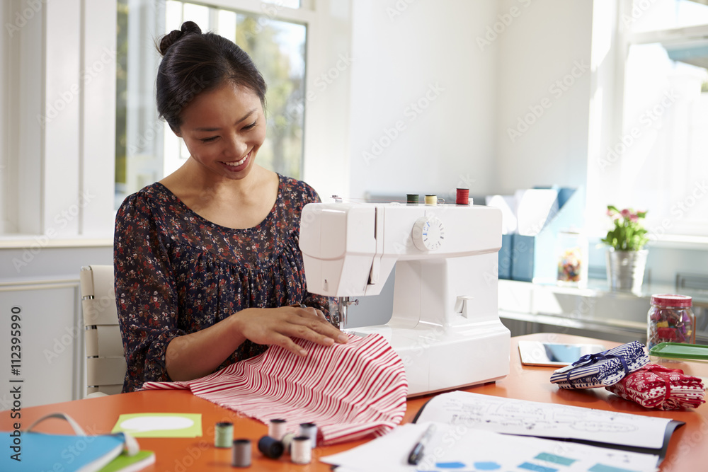 Woman Making Clothes Using Sewing Machine At Home Woman Making Clothes Using Sewing Machine At Home