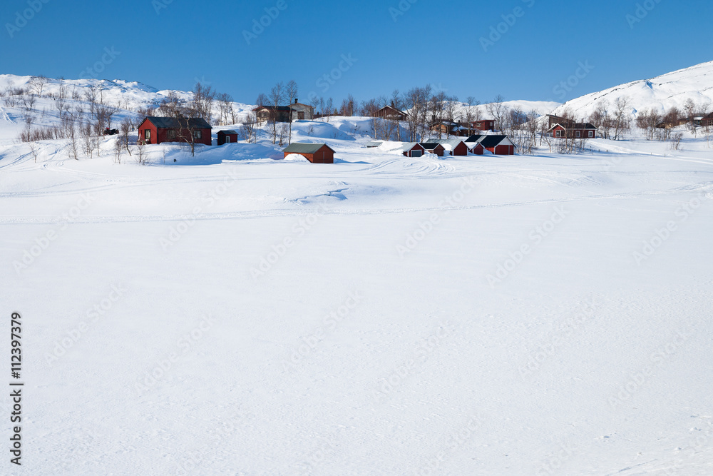 Rote Ferienhäuser in der weißen Winterlandschaft in Schweden