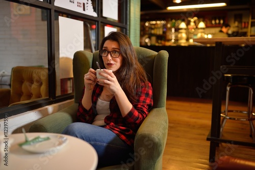 Young beautiful woman having coffee