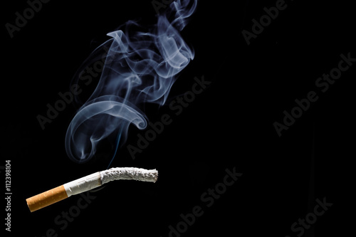 Cigarette burning and smoke with  black background