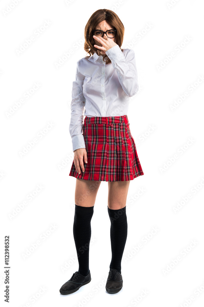 Teen student girl making smelling bad gesture Teen student girl making smelling bad gesture