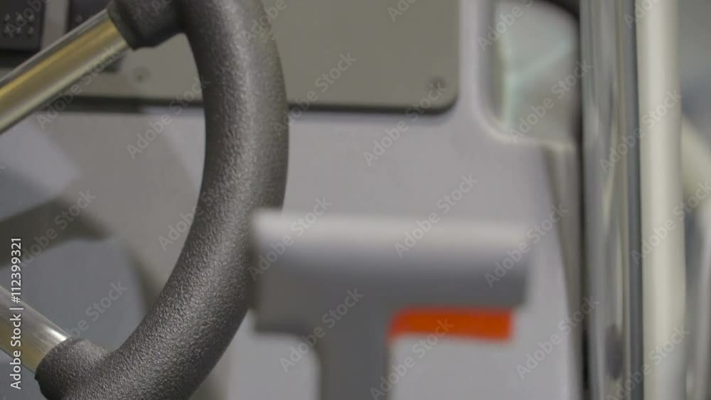 Driver sear with the steering wheel of a yacht the gray buttons on the front and the pushing lever on the right of the seat