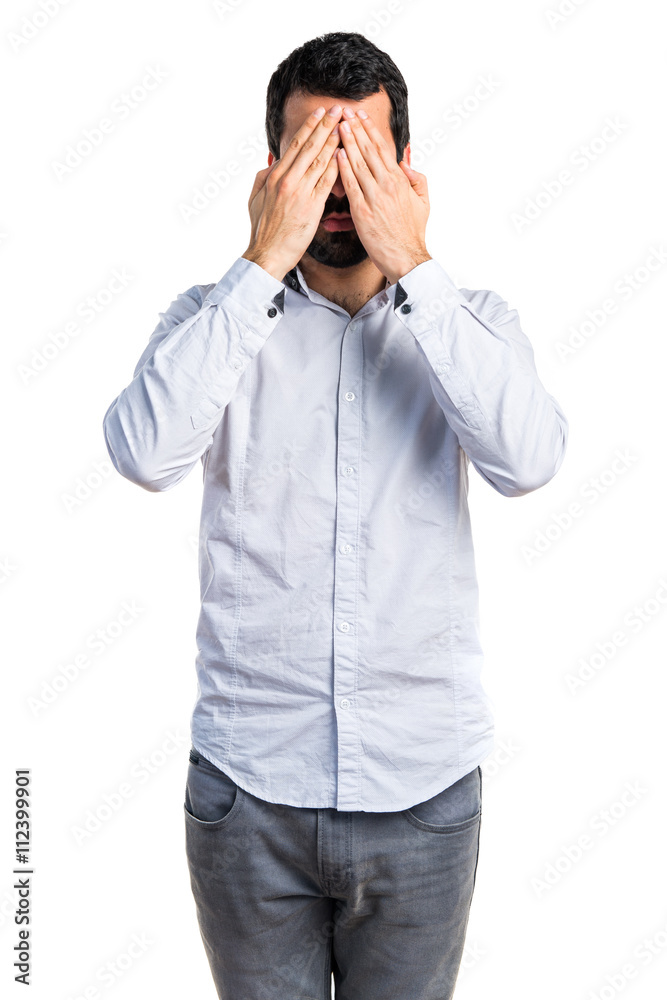 Man covering his eyes Man covering his eyes