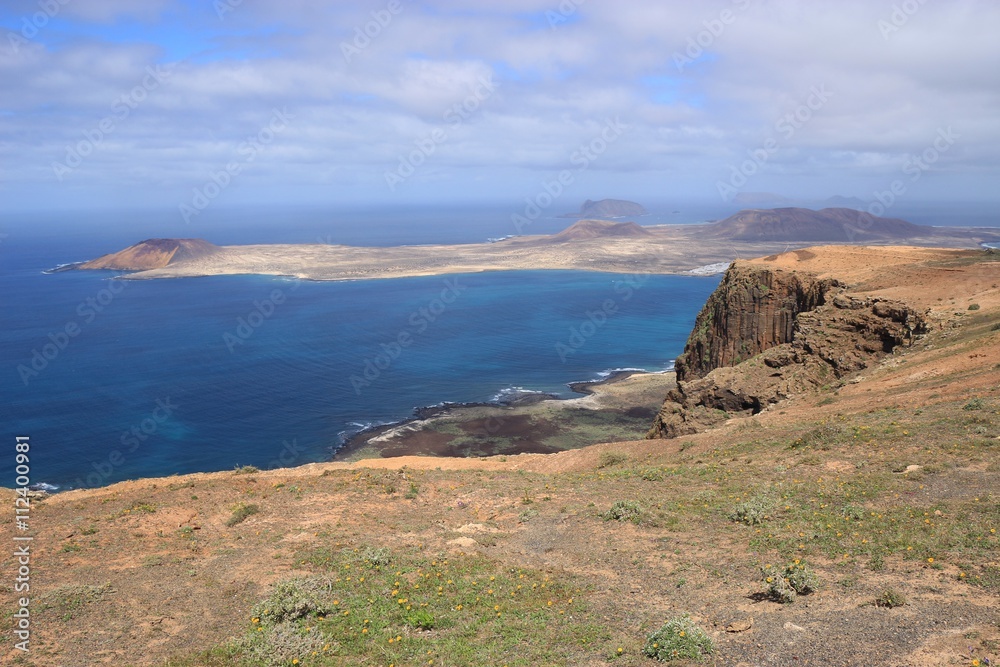 On a high plateau of the Chinijo Archipelago nature park, Lanzarote, Canary Islands. View of the island La Graciosa. On a high plateau of the Chinijo Archipelago nature park, Lanzarote, Canary Islands. View of the island La Graciosa.