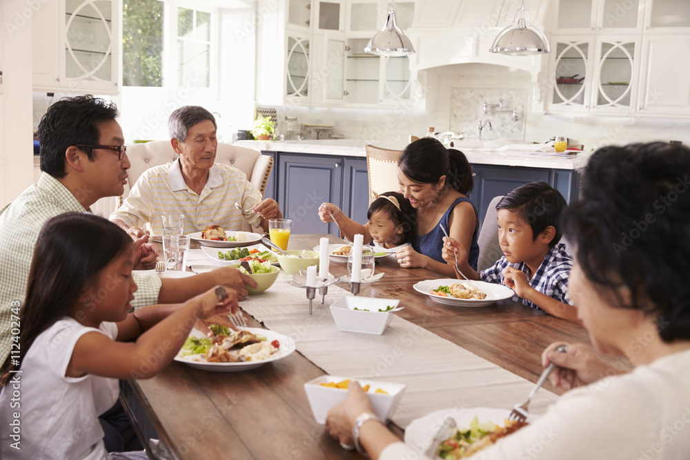 Extended Family Group Eating Meal At Home Together Extended Family Group Eating Meal At Home Together