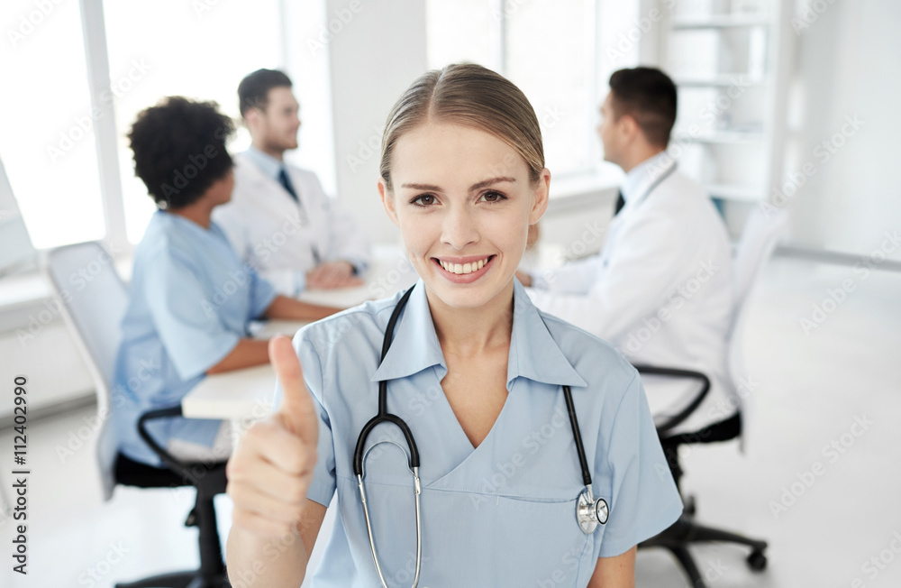 happy doctor over group of medics at hospital