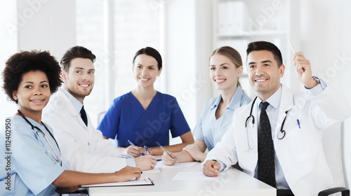 group of happy doctors on conference at hospital photo