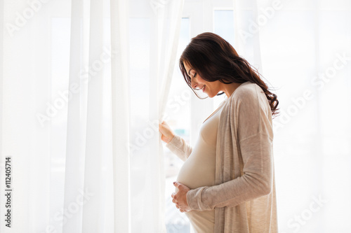 Obraz na płótnie close up of happy pregnant woman with big belly