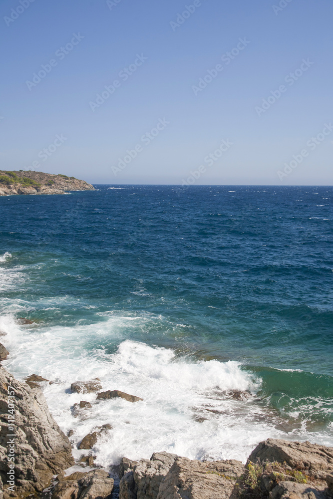 Beautiful view of waves crushing against the rocks at Mediterranean Sea.