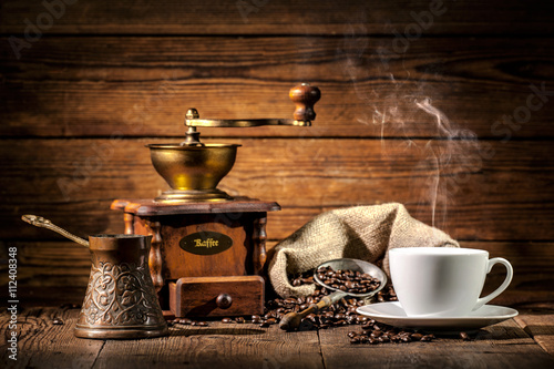 Coffee grinder, turk and cup of coffee