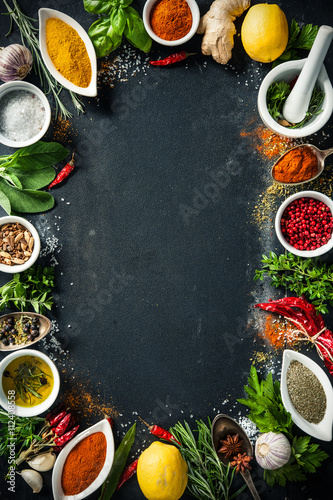 Fototapeta Naklejka Na Ścianę i Meble -  Herbs and spices over black stone background