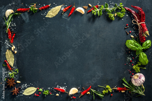 Fototapeta Naklejka Na Ścianę i Meble -  Herbs and spices over black stone background