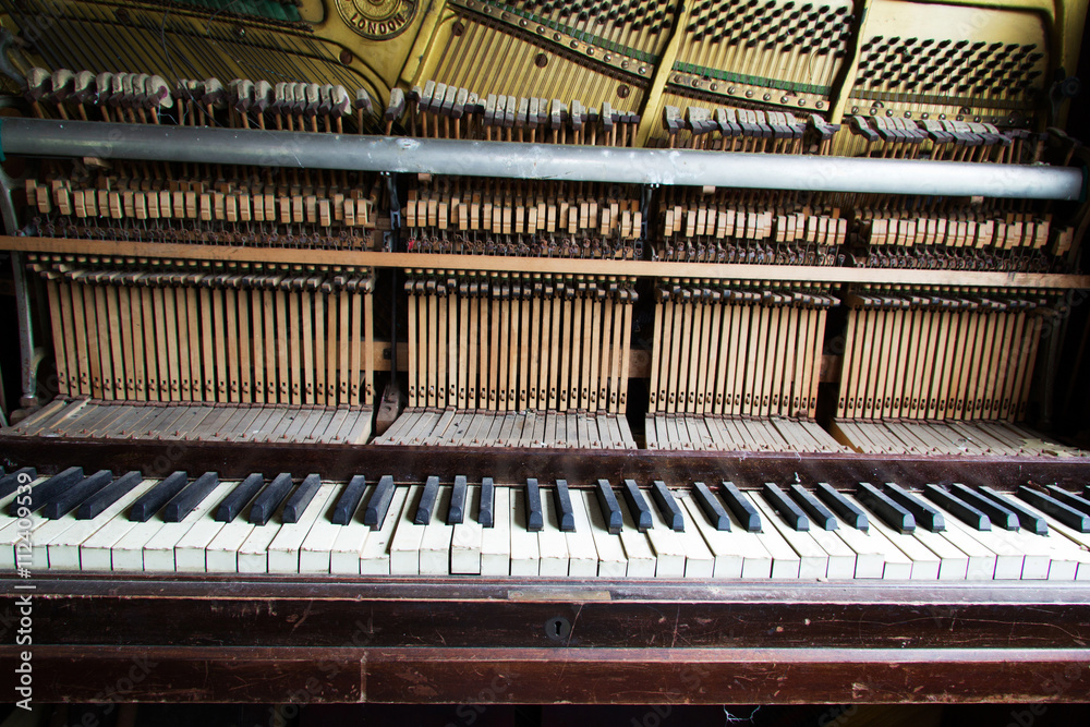 Old broken disused piano with damaged keys Old broken disused piano with damaged keys
