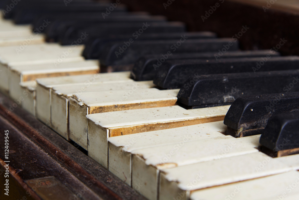 Old broken disused piano with damaged keys