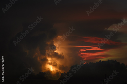 A lightning bolt in the sky during sunset