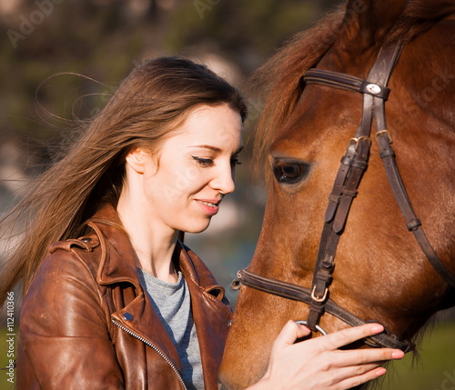 Woman and horse. Portrait close up