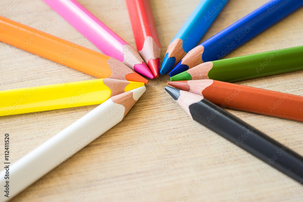 Obraz premium Color Pencils on wood texture. Macro shot of colorful pencils. Horizontal view of pencils. Selective focus.
