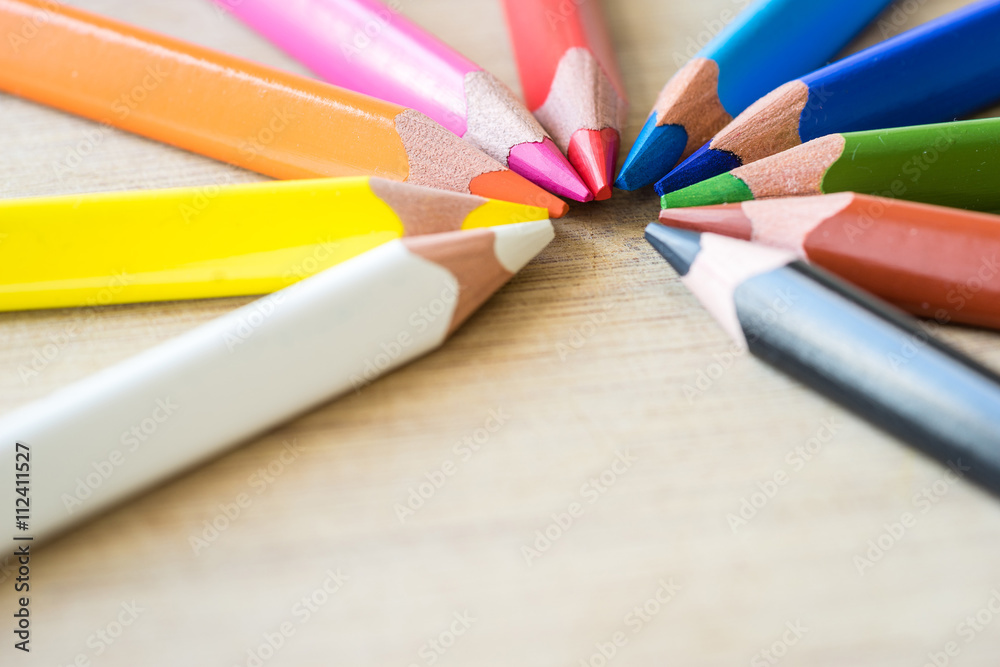 Obraz premium Color Pencils on wood texture. Macro shot of colorful pencils. Horizontal view of pencils. Selective focus.