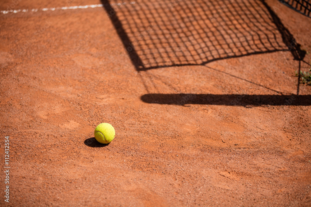 Tennis balls on the ground of clay court