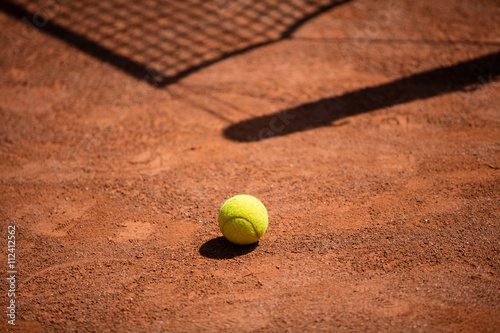 Tennis balls on the ground of clay court © Yordan Rusev