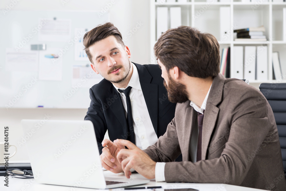 Handsome businessmen discussing business project Handsome businessmen discussing business project