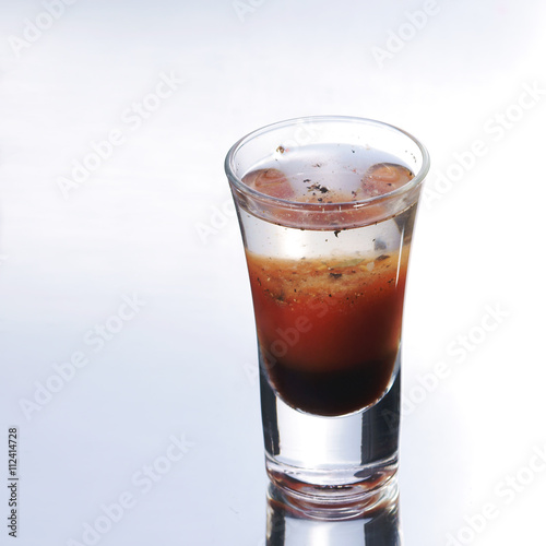 Colorful layered shot isolated on white gray gradient background with reflection. Alcohol shooter