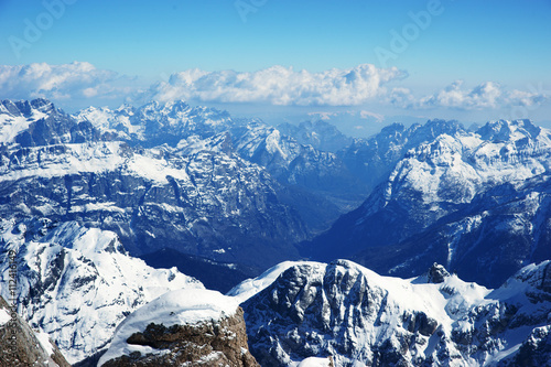 Scenic view on snowy peaks in italian dolomiti alps on a sunny day. Arabba Marmalada 