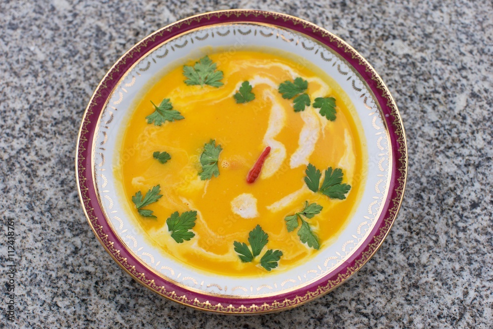 Sweet potato creamy soup asian or thai style vegan soup prepared from sweet potatoes or yam with chilli, curry, coconut milk, ginger, onion and fresh leaves of coriander. Fresh and spicy healthy food. Sweet potato creamy soup asian or thai style vegan soup prepared from sweet potatoes or yam with chilli, curry, coconut milk, ginger, onion and fresh leaves of coriander. Fresh and spicy healthy food.