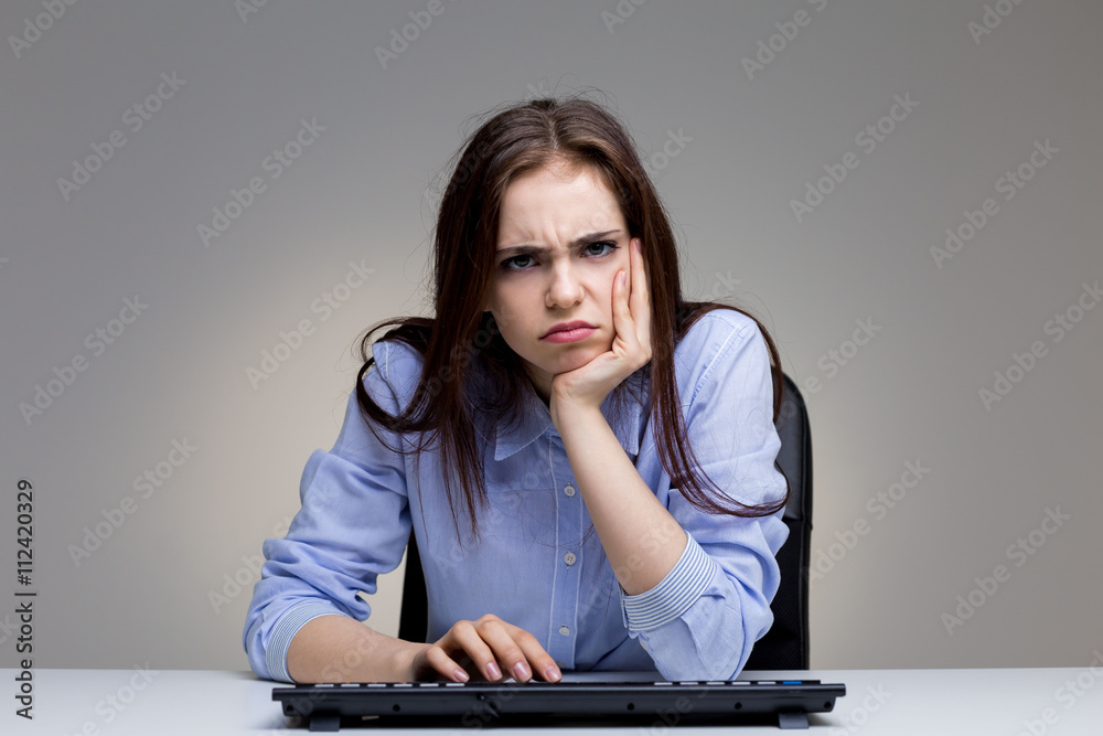 Grumpy woman using keyboard Grumpy woman using keyboard