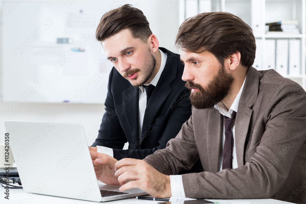 Handsome businesspeople discussing project Handsome businesspeople discussing project
