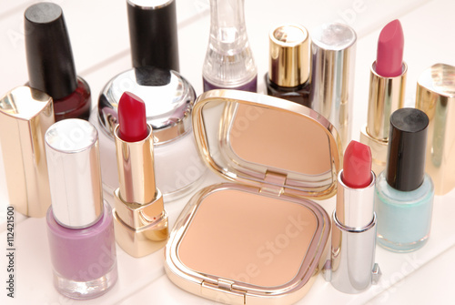 cosmetics, lipsticks, varnish, cream are on dressing table