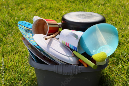 Dirty plates and dishes on a campsite waiting to be washed up