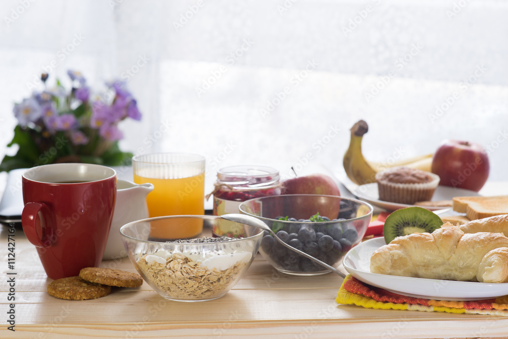 Breakfast on wooden table of sunny morning