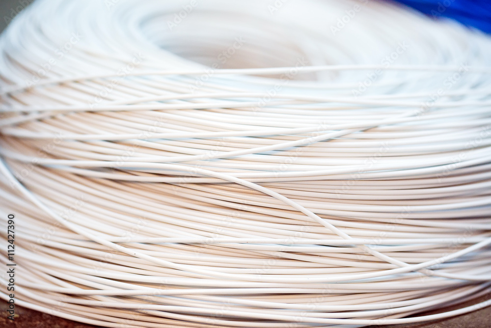 close up a roll of white cable close up a roll of white cable