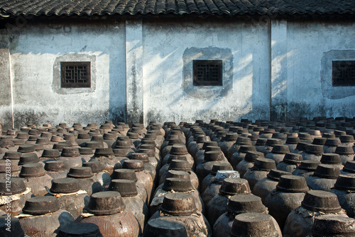 Shanghai, Jugs of distilled rice liquor at Sanbai Wine Workshop in Wuzhen historic scenic town. photo