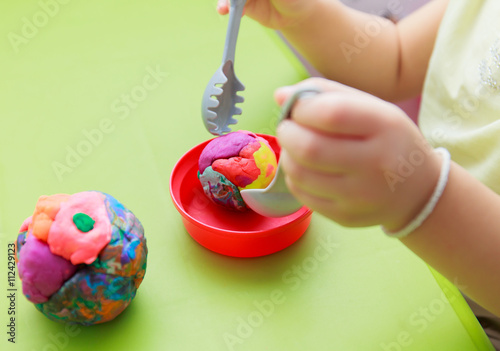 Childs hands Play Doh