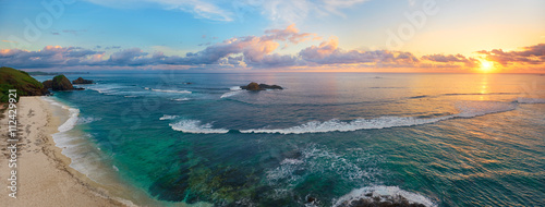 Panoramic view of tropical beach with surfers at sunset. © soft_light