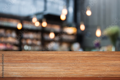 Top wooden table with cafe background