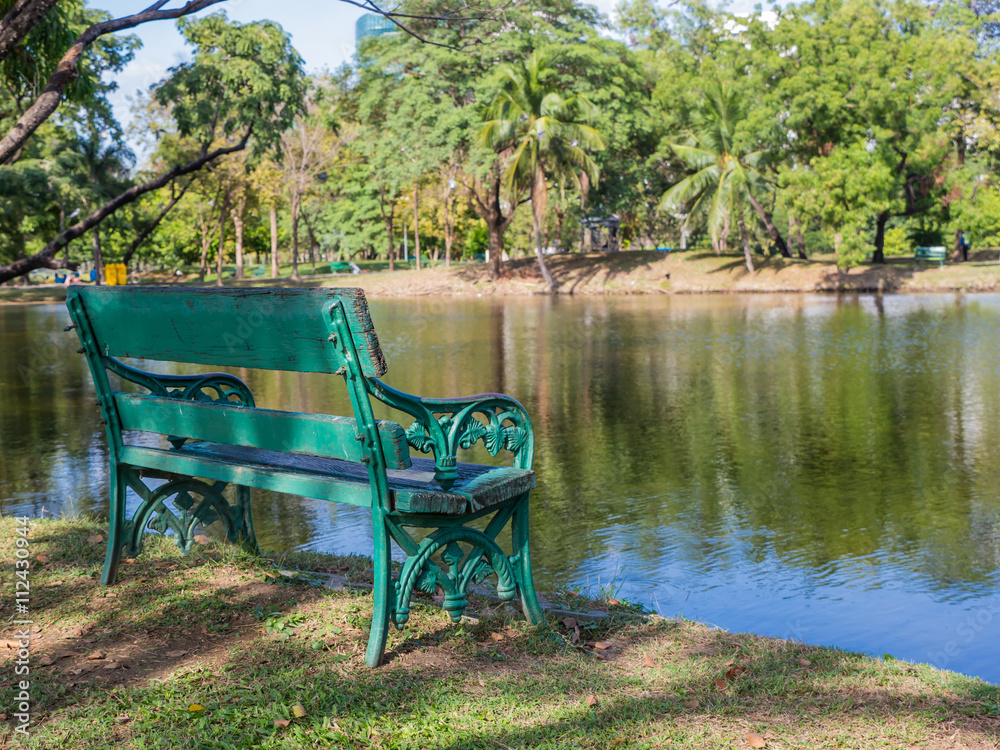 Empty wooden chair in public park