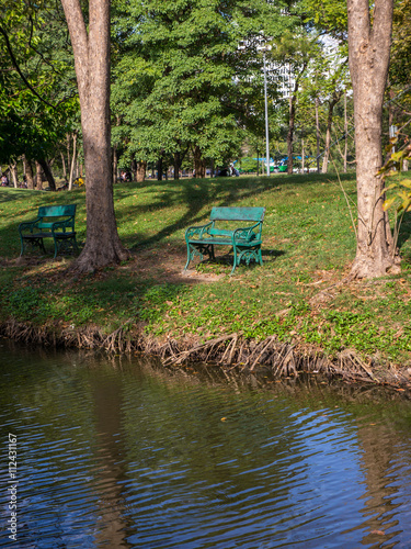 Empty wooden chair in public park