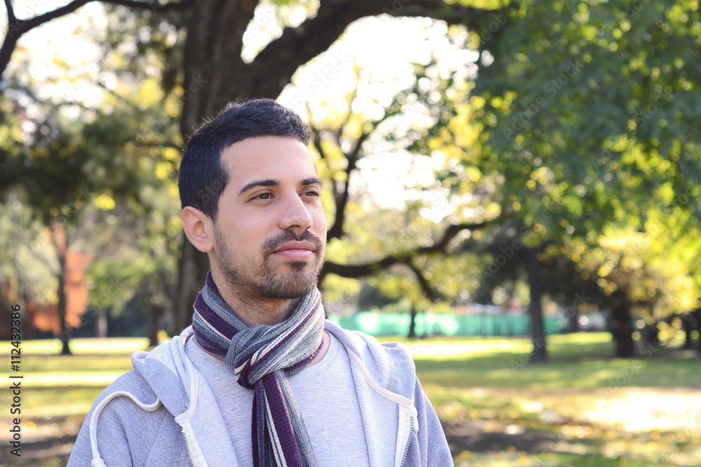 Close up of young man in a park. Close up of young man in a park.