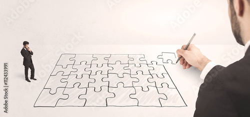 Business man looking at hand drawing solution