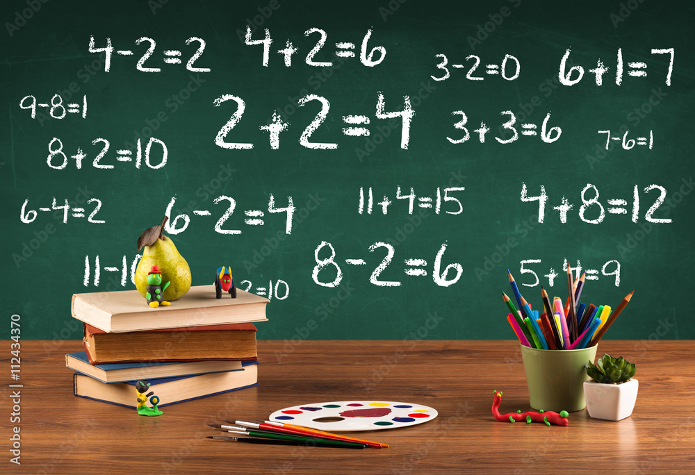 School blackboard with pile of books School blackboard with pile of books