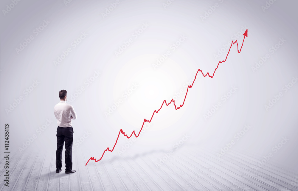 Standing businessman with red graph arrow Standing businessman with red graph arrow