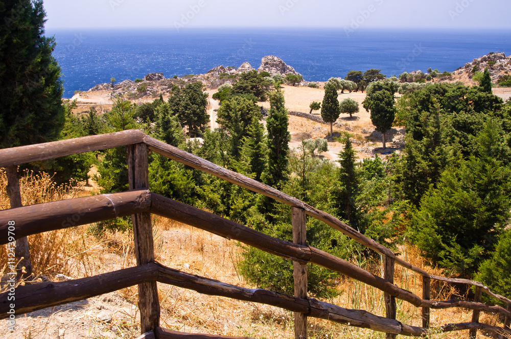 Stairway with a wooden fence to the coast of Lybian sea, island of Crete, Greece