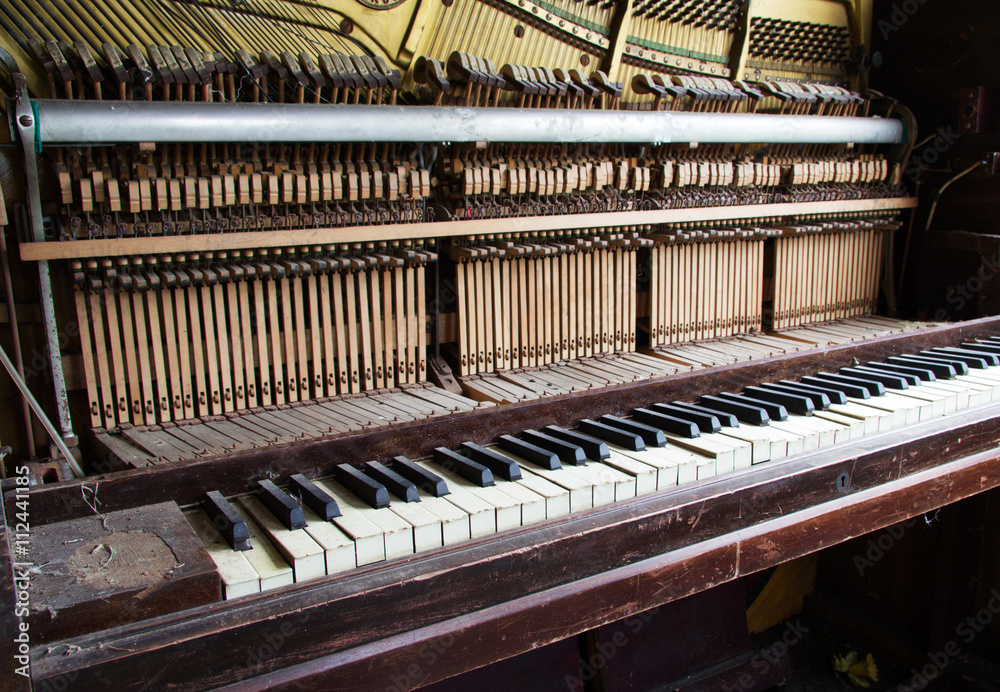 Old broken disused piano with damaged keys Old broken disused piano with damaged keys