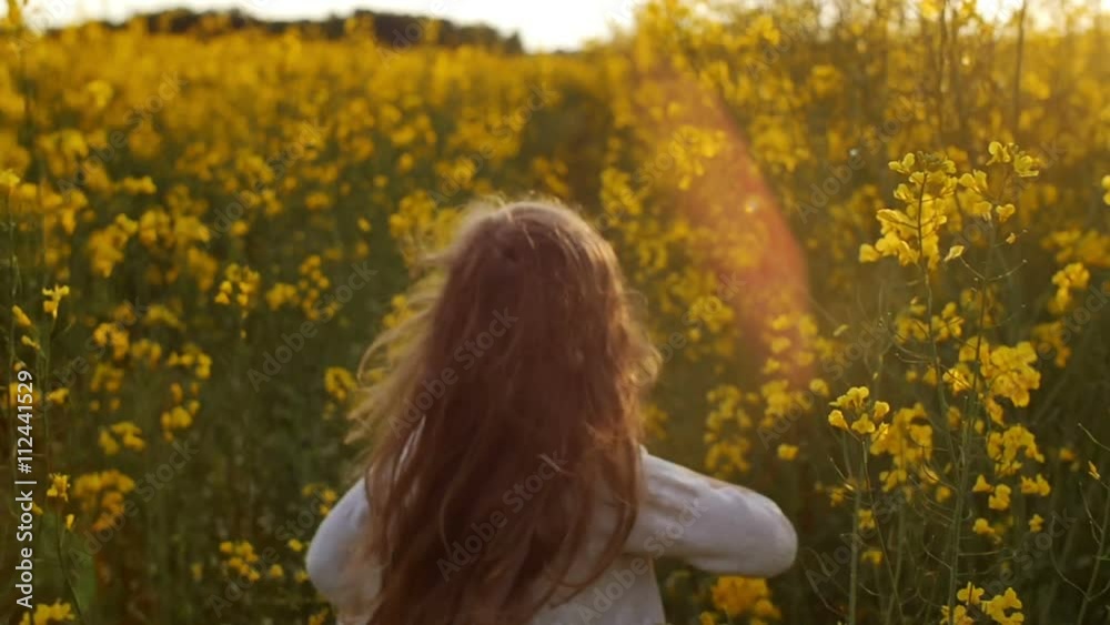 girl running cross the field at sunset.Slow motion
