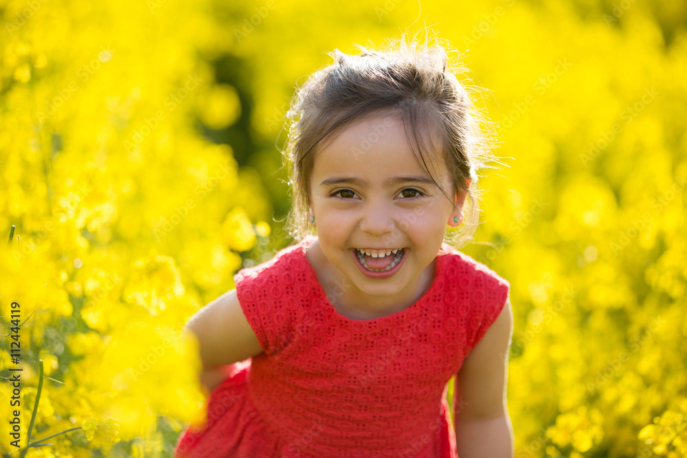 beautiful little girl playing in colza field beautiful little girl playing in colza field